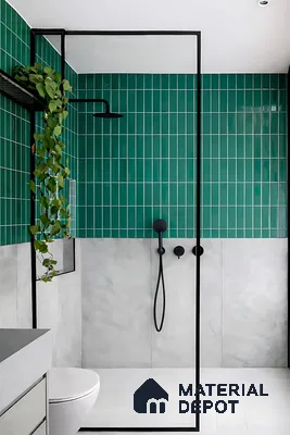Modern bathroom with emerald green vertical subway wall tiles and matte grey stone look wall tiles