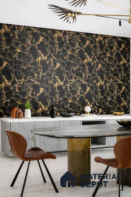 Modern dining room with black marble fluted wall panels and brass pedestal dining table