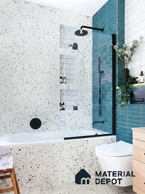 Modern bathroom with terrazzo wall and floor tiles, blue kitkat subway highlighter tiles, and black fixtures