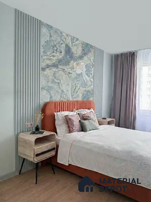 Modern bedroom with marble-effect wallpaper, fluted wall panels, and suede upholstered bed
