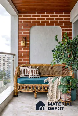 Bohemian balcony with brick cladding, rattan sofa, and marble look floor tiles
