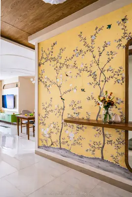 Eclectic foyer with yellow chinoiserie wallpaper, wooden floating shelf, and glossy beige floor tiles