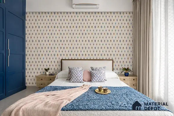 Modern bedroom with blue wardrobe, patterned wallpaper, and beige laminate nightstands in 4 BHK apartment Cumin Genesis Apartment KR Puram Bengaluru