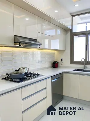 Modern kitchen with high gloss cream laminate, white quartz countertop, and geometric white backsplash tile in 3 BHK apartment DS Max Scarlet Ashirvad Colony Bengaluru