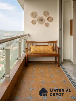 Bohemian balcony with terracotta patterned floor tiles and wooden bench seating