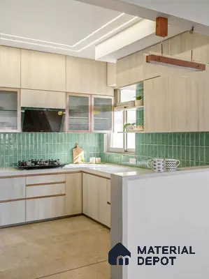 Scandinavian kitchen with light wood laminate cabinets, green kitkat backsplash tiles, and white quartz countertop