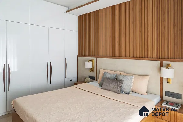 Modern bedroom with white high gloss laminate wardrobe and vertical oak wood fluted wall panels of 3 BHK apartment in Garuda Royal Homes KR Puram in Bengaluru