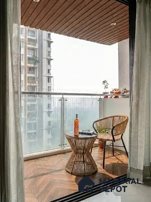 Modern balcony with wood-look tile flooring and rattan furniture