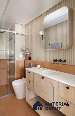 Modern bathroom with beige fluted wall tiles, terracotta floor tiles, and light wood vanity