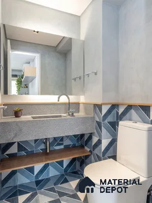 Modern bathroom with blue geometric patterned tiles and grey stone countertop