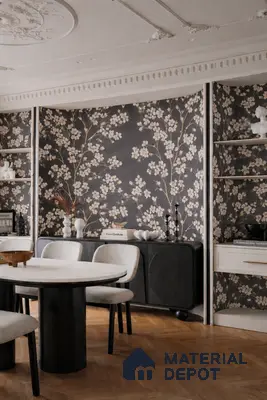 Art Deco dining room with floral wallpaper, black sideboard, and herringbone wood flooring