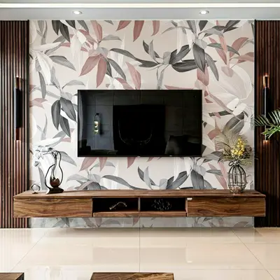 Modern TV unit with floral wallpaper, walnut wood floating cabinet, and vertical wood louvers in 2 BHK apartment JS Sunflower Anantapuram Bengaluru