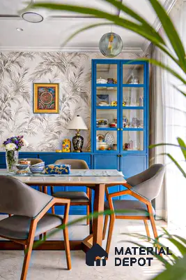 Eclectic dining room with blue cabinet, palm patterned wallpaper, and marble top dining table