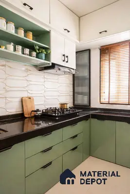 Modern dual tone kitchen with sage green and frosty white laminate, black granite countertop, and textured beige wall tiles