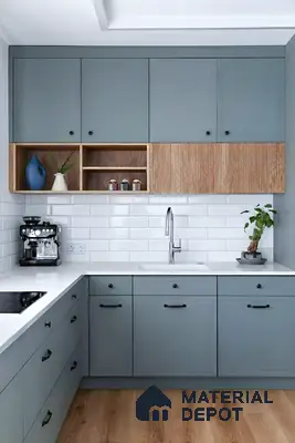 Scandinavian kitchen with blue-grey laminate cabinets, white quartz countertop, and oak wood laminate accents of 4 BHK apartment in Jain Heights East Parade Kaggadasapura Bengaluru