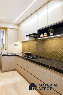 Modern kitchen with beige high gloss laminate, black marble countertop, and olive green herringbone backsplash tile of 3 BHK apartment in Jana Jeeva orchid KR puram Bengaluru