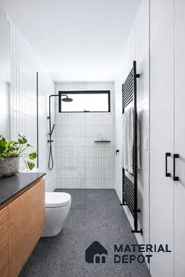 Minimalist bathroom with white vertical subway wall tiles, black granite countertop, and speckled grey floor tiles
