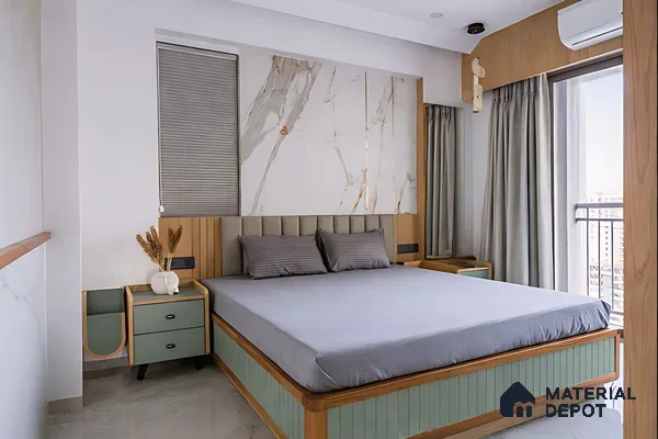 Modern bedroom with sage green laminate, marble-look accent wall, and light wood finishes