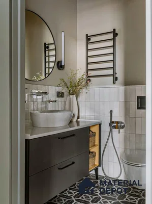 Modern bathroom with white vertical subway wall tiles, black geometric patterned floor tiles, and matte black vanity
