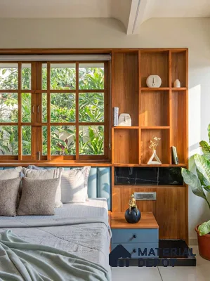 Scandinavian bedroom with natural wood shelving, blue upholstered headboard, and black marble accent