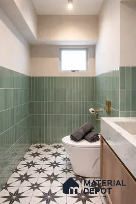 Modern bathroom with sage green vertical subway wall tiles and black-and-white geometric patterned floor tiles