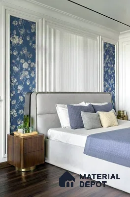 Modern bedroom with blue floral wallpaper, white fluted wall panels, and dark wood flooring