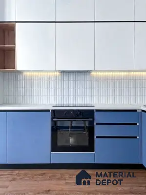 Modern dual tone kitchen with blue and white laminate, white quartz countertop, and vertical white subway backsplash tiles