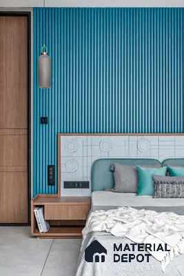 Modern bedroom with blue fluted wall panels and natural wood laminate furniture
