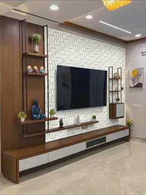 Modern TV unit with walnut brown wood laminate, geometric white and gold accent wall, and glossy floor tile in 3 BHK apartment LVS Heights KR Puram Bengaluru