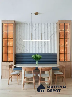 Scandinavian dining room with fluted marble accent wall, light oak wood cabinetry, and upholstered banquette seating