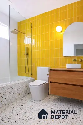 Modern bathroom with yellow vertical subway wall tiles, terrazzo floor tiles, and wooden vanity