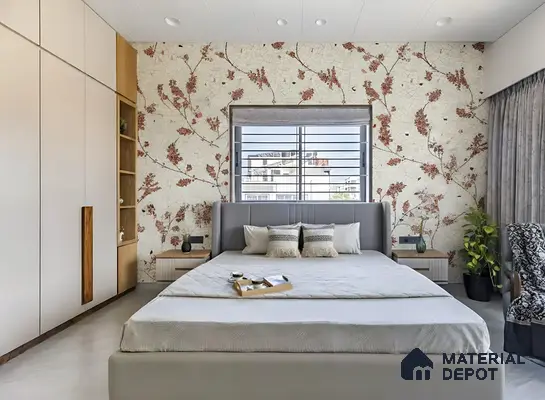 Modern bedroom with floral wallpaper, frosty white laminate wardrobe, and grey upholstered bed of 2 BHK apartment in Mahaveer Dazzle Mahadevapura Bengaluru
