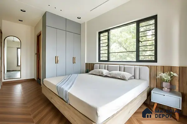 Scandinavian bedroom with pastel blue wardrobe, wood-look chevron flooring, and upholstered headboard of 3 BHK apartment in Mahaveer Rich Jalahalli Bengaluru