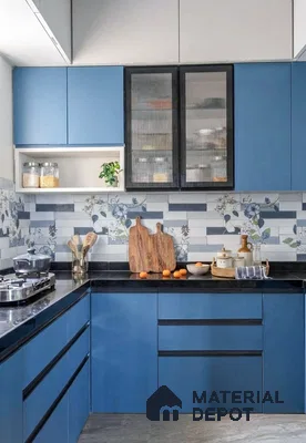 Modern kitchen with blue laminate cabinets, floral and striped backsplash tiles, and black granite countertop in 3 BHK apartment Maithri Shilpitha Splendour Mahadevapura Bengaluru