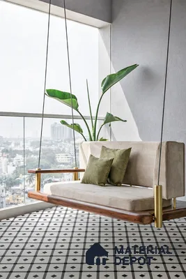 Minimalist balcony with patterned black-and-white floor tiles and wooden swing seating