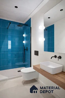 Modern bathroom with blue kitkat wall tiles, floating wood vanity, and matte beige floor tiles