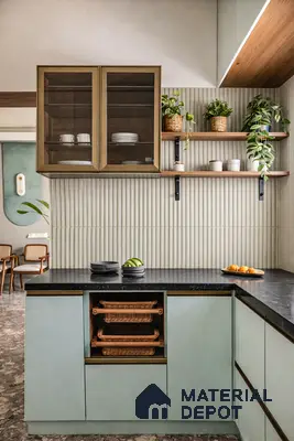 Scandinavian kitchen with sage green laminate cabinets, black granite countertop, and fluted beige wall tiles