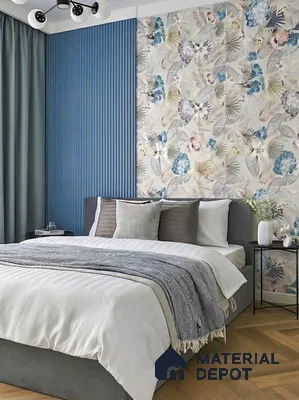 Modern bedroom with blue fluted wall panels, floral wallpaper, and herringbone wooden flooring