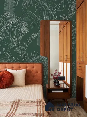 Mid-century modern bedroom with tropical green wallpaper, teak wood wardrobe, and suede upholstered bed