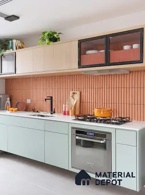 Modern kitchen with pastel green laminate, white quartz countertop, and terracotta fluted backsplash tiles