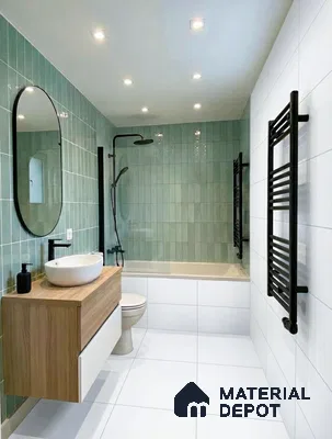 Modern bathroom with sage green subway wall tiles, white floor tiles, and wood floating vanity in 2 BHK apartment NCN Gold Kalyan Nagar Bengaluru