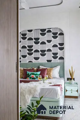 Modern bedroom with geometric wallpaper, mint green upholstered bed, and pastel bedside table