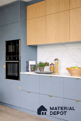 Modern kitchen with pastel blue laminate, oak wood laminate, and white marble backsplash