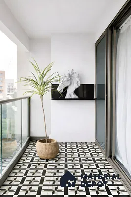 Modern balcony with black-and-white geometric patterned floor tiles and glass railing