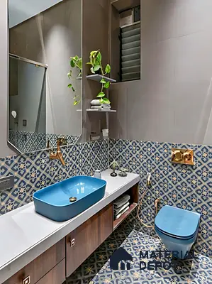 Modern bathroom with blue patterned moroccan tiles, matte grey wall tiles, and blue ceramic sanitaryware