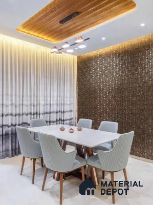 Modern dining room with white marble tabletop, geometric metallic accent wall, and wooden ceiling panel