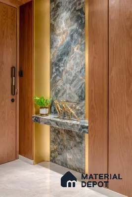 Modern foyer with walnut wood laminate, blue-grey marble accent wall, and gold accent profiles
