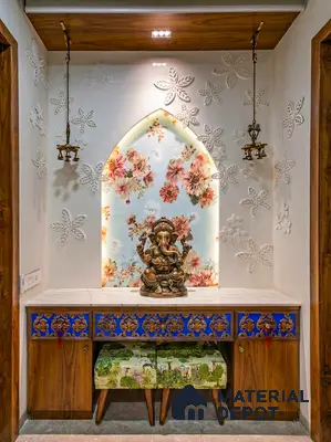 Traditional pooja room with floral wallpaper, carved blue and gold cabinet, and marble countertop