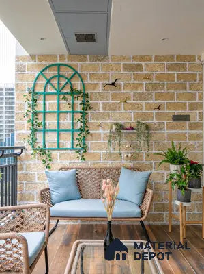 Mediterranean balcony with beige stone cladding, rattan furniture, and wooden floor tiles