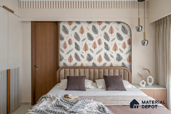 Scandinavian bedroom with leaf patterned wallpaper, suede upholstered bed, and light wood accents